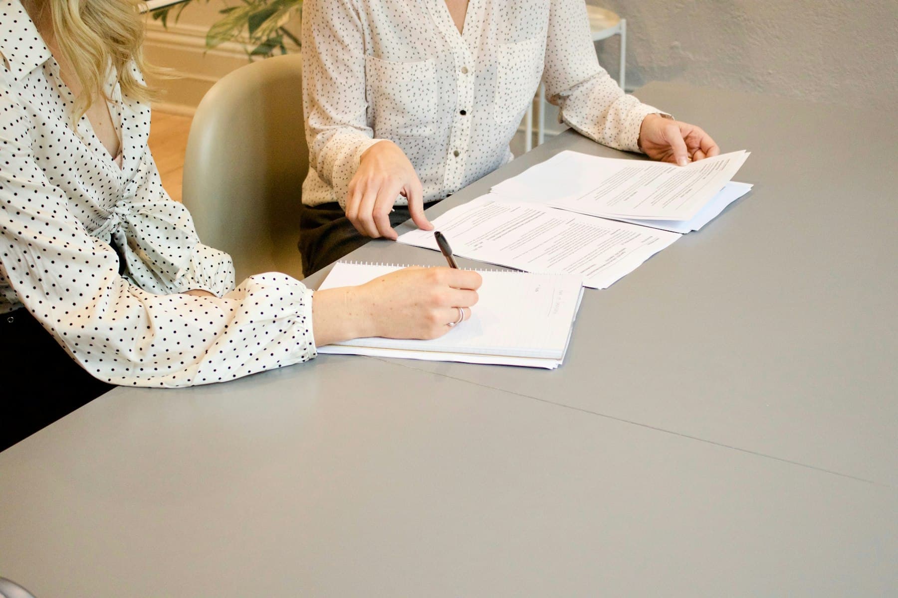 A print professional reviewing a project with a customer at the shop counter